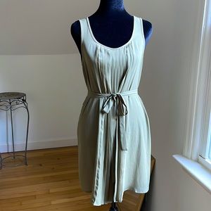 Sage green dress. Sleeveless. Pleated front detail.